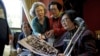 South Korean participants for a reunion check old pictures at a hotel used as a waiting place in Sokcho, South Korea, Oct. 19, 2015.