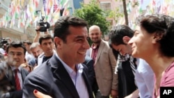 Greeted by supporters, Selahattin Demirtas, leader of pro-Kurdish Peoples' Democracy Party, smiles as he arrives at his party headquarters in Ankara, Turkey, June 9, 2015.