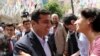 FILE - Greeted by supporters, Selahattin Demirtas, leader of pro-Kurdish Peoples' Democracy Party, smiles as he arrives at his party headquarters in Ankara, Turkey, June 9, 2015.