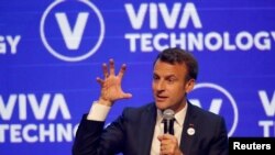 FILE - French President Emmanuel Macron delivers a speech at the VivaTech startups and innovation fair in Paris, France May 16, 2019.