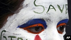 FILE - A girl's face is painted with a message decrying female feticide, as part of a face-painting competition in the northern Indian city of Chandigarh.