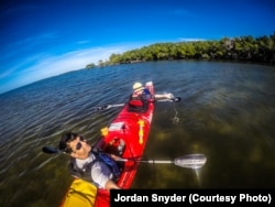 Jordan Synder and Martina Sestakova taking water samples in the remote Florida Everglades for the Adventure Scientists' Worldwide Microplastics Database. (Credit: Jordan Synder)