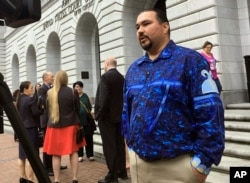 FILE - In this March 13, 2019, file photo, Tehassi Hill, tribal chairman of the Oneida Nation, stands outside a federal appeals court in New Orleans, following arguments on the constitutionality of a 1978 law giving Native American families preference in adoption of Native American children.