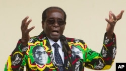 FILE - Zimbabwean President Robert Mugabe addresses people at an event before the closure of his party's 16th Annual Peoples Conference in Masvingo, south of the capital Harare. 