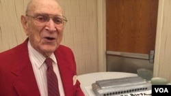 Jack Hopkins with his harmonica cake as he turned 97 years old at the Virginia Harmonica Fest. (C/ Presutti/VOA)