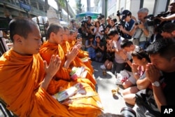 Buddhist monks hold a prayer at the Erawan Shrine at Rajprasong intersection in Bangkok, Thailand, Aug. 19, 2015.