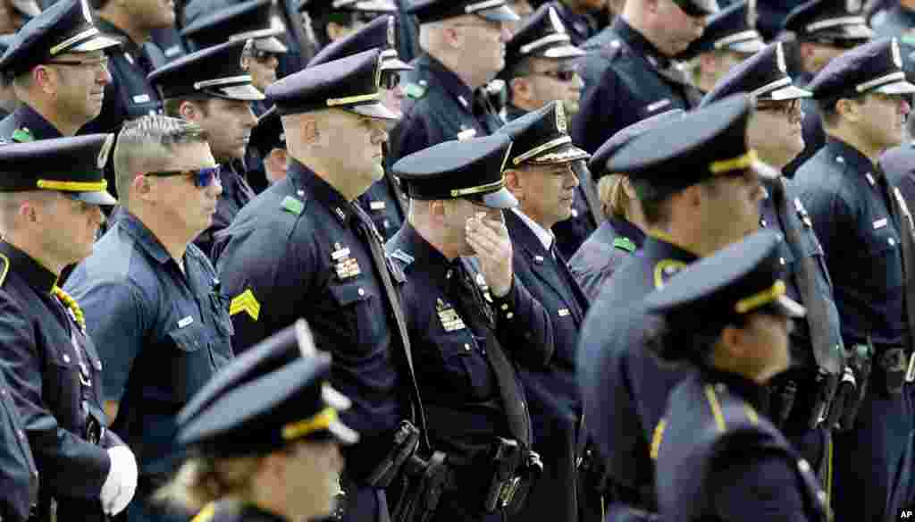 Dallas Police officers watch an honor guard presentation for slain Dallas Police officer Michael Krol after a funeral service at Prestonwood Baptist Church in Plano, Texas, July 15, 2016.