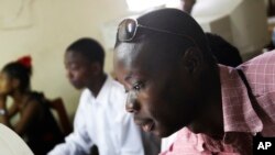 FILE - Momulu Norman, 22, teaches at a computer school in Monrovia, Liberia.
