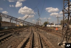 A railway worker walks near damaged pillar after Russian airstrike in Pokrovsk, Ukraine, Sept. 17, 2024.