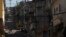 An elite police officer, bottom left, patrols one day after police came under fire during a shift change in the Alemao slum complex in Rio de Janeiro, Brazil, July 16, 2018. Rio is experiencing a wave of violence as gangs vie for control and police strugg