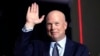 FILE - Former acting Attorney General Matt Whitaker waves as Donald Trump speaks at a caucus night party in Des Moines, Iowa, on Jan. 15, 2024. President-elect Trump on Nov. 20, 2024, announced Whitaker as his choice to be the U.S. ambassador to NATO.