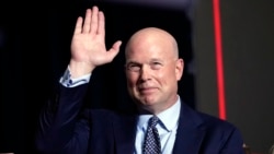 FILE - Former acting Attorney General Matt Whitaker waves as Donald Trump speaks at a caucus night party in Des Moines, Iowa, on Jan. 15, 2024. President-elect Trump on Nov. 20, 2024, announced Whitaker as his choice to be the U.S. ambassador to NATO.