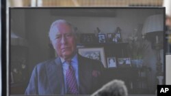 A view of Britain's Prince Charles projected on a screen to delivering a video message from his residence in Scotland, during the opening of the NHS Nightingale Hospital in London, April 3, 2020.