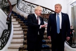 FILE - President Donald Trump and Britain's Prime Minister Boris Johnson speak to reporters before a meeting at the Hotel du Palais on the sidelines of the G-7 summit in Biarritz, France, Aug. 25, 2019.