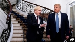 FILE - President Donald Trump and Britain's Prime Minister Boris Johnson, left, speak to the media before a working breakfast meeting at the Hotel du Palais on the sidelines of the G-7 summit in Biarritz, France, Aug. 25, 2019.