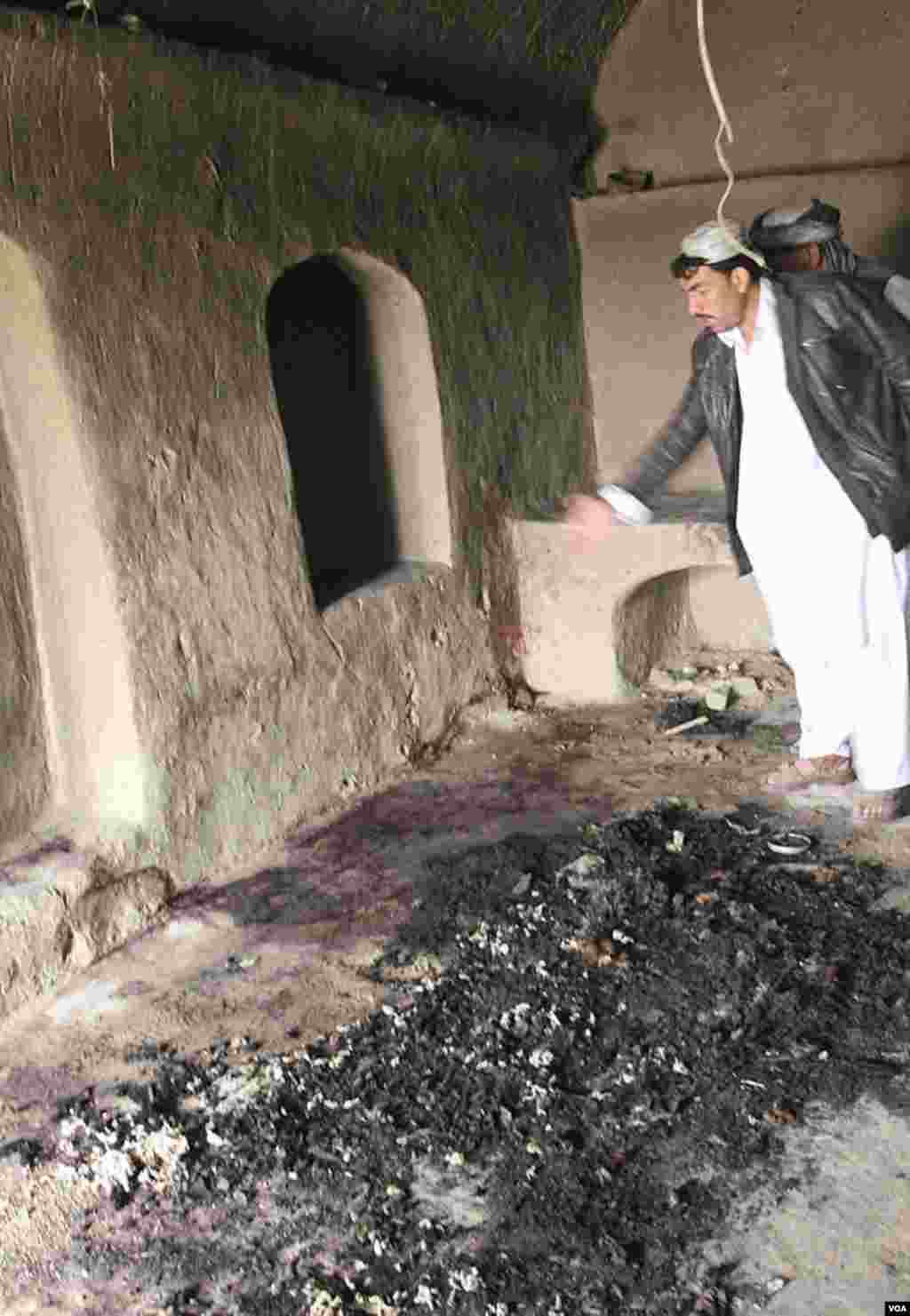 A man points to bloodstains, where witnesses say Afghans were killed by a U.S. service member, in Panjwai. (AP)