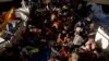 Migrants rest on the deck of the German NGO migrant rescue ship Sea-Watch 3 in international waters north of Libya, in the western Mediterranean Sea, August 2, 2021. (REUTERS/Darrin Zammit)