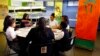 First lady Michelle Obama, center left, pours a smoothie while visiting students at Philip's Academy Charter School in Newark, N.J., as part of her American Garden Tour, April 7, 2016.