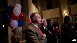 Former Alabama Chief Justice and U.S. Senate candidate Roy Moore, stops to say the Pledge of Allegiance as he walks around greeting supporters before his election party, Tuesday, Sept. 26, 2017, in Montgomery, Alabama. 