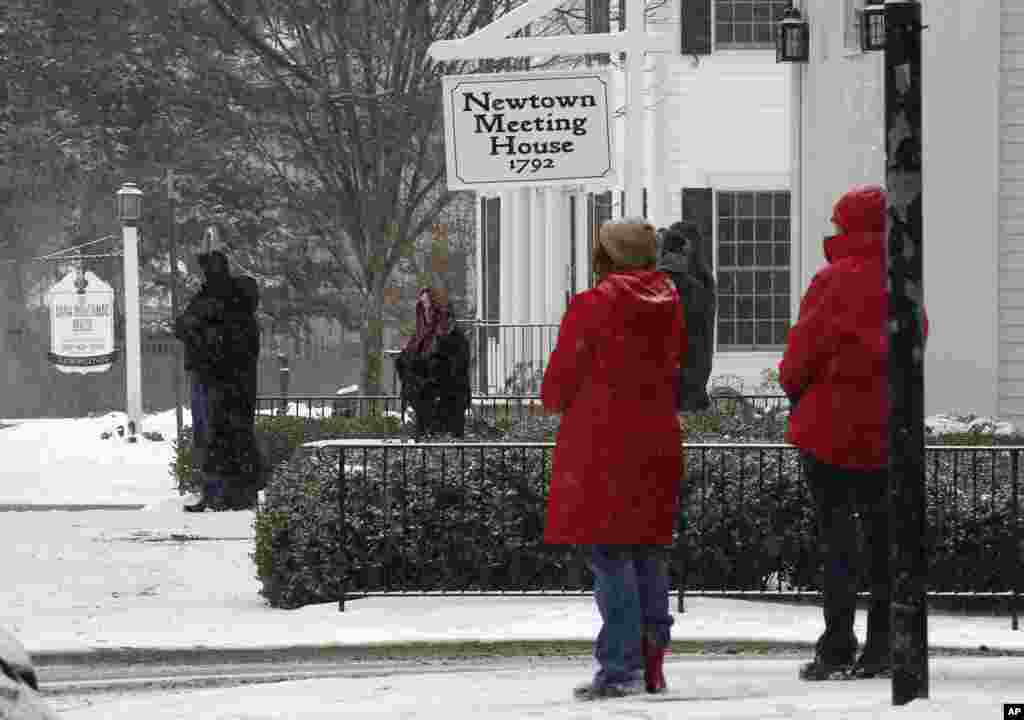 People pause in silence while church bells ring in honor of the victims of the Sandy Hook massacre, Newtown, Conn.,&nbsp;Dec. 14, 2013.