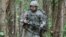 In a May 9, 2012 photo, Capt. Sara Rodriguez of the 101st Airborne Division walks through the woods during the expert field medical badge testing at Fort Campbell, Ky., on May 9, 2012.