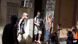 Turistas salen de una vivienda privada de alquiler en La Habana, Cuba.