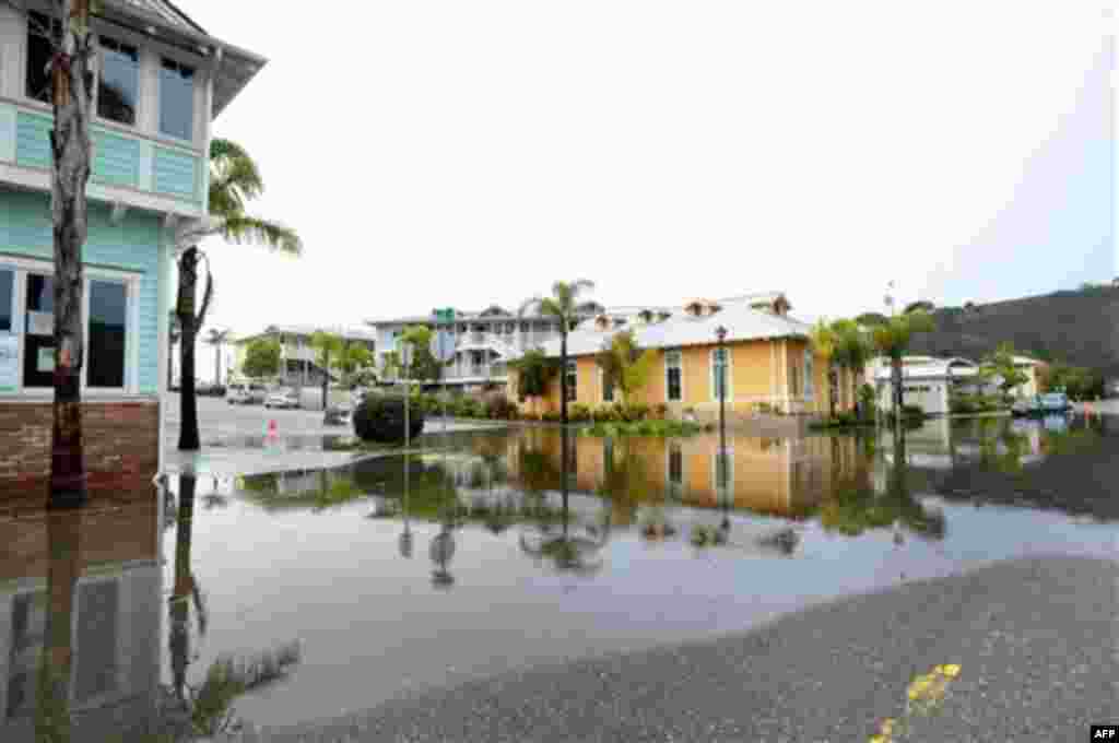 A road is closed due to flooding during a rain storm in Avila Beach, Calif., Wednesday, Dec. 22, 2010. A storm walloped parts of California and spawned minor flooding, mudslides and road closures, but forecasters warn the bad weather's real impact may be 