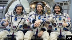 From left: CSA astronaut David Saint Jacques, Russian cosmonaut Оleg Kononenko‎ and U.S. astronaut Anne McClain pose in a mock-up of a Soyuz space craft at Russian Space Training Center in Star City, Russia, Nov. 14, 2018. 