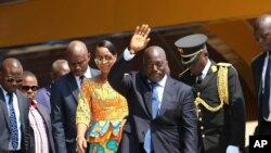 FILE - Democratic Republic of Congo President Joseph Kabila, center, waves as he and others celebrate the DRC's independence day, in Kindu, DRC, June 30, 2016. Under the DRC's constitution, Kabila should step down when his second term expires in December.