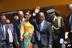 FILE - Democratic Republic of Congo President Joseph Kabila, center, waves as he and others celebrate the DRC's independence day, in Kindu, DRC, June 30, 2016.