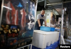 Atsushi Kobayashi, a live squid trader, stands at his shop in Ota Wholesale Market in Tokyo, Japan, July 23, 2018.