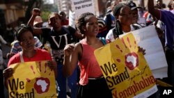 FILE - People rally during a march against xenophobia, in downtown Johannesburg, South Africa, 2015. Anti-foreigner sentiments have been on the rise in the country which, according to most recent data, is home to some two million foreign nationals.