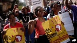 FILE - People rally during a march against xenophobia, in downtown Johannesburg, South Africa, 2015. Anti-foreigner sentiments have been on the rise in the country which, according to most recent data, is home to some two million foreign nationals.