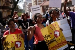 FILE - People rally during a march against xenophobia, in downtown Johannesburg, South Africa, 2015. Anti-foreigner sentiments have been on the rise in the country which, according to most recent data, is home to some two million foreign nationals.