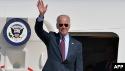 U.S. Vice President Joe Biden waves after landing at Boryspil International Airport in Kyiv April 21, 2014.