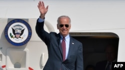 ຣອງປະທານາທິບໍດີສະຫະລັດ Joe Biden ໂບກມືໃສ່ປະຊາຊົນ ຫຼັງຈາກເດີນທາງໄປຮອດ ສະໜາມບິນລະຫວ່າງຊາດ Boryspil ທີ່ນະຄອນຫຼວງ Kyi, ວັນທີ 21 ເມສາ, 21014.