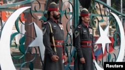 FILE - Pakistani Rangers take part in the daily flag lowering ceremony at the India-Pakistan joint border at Wagah some 20 km (12 miles) to the east of Lahore.