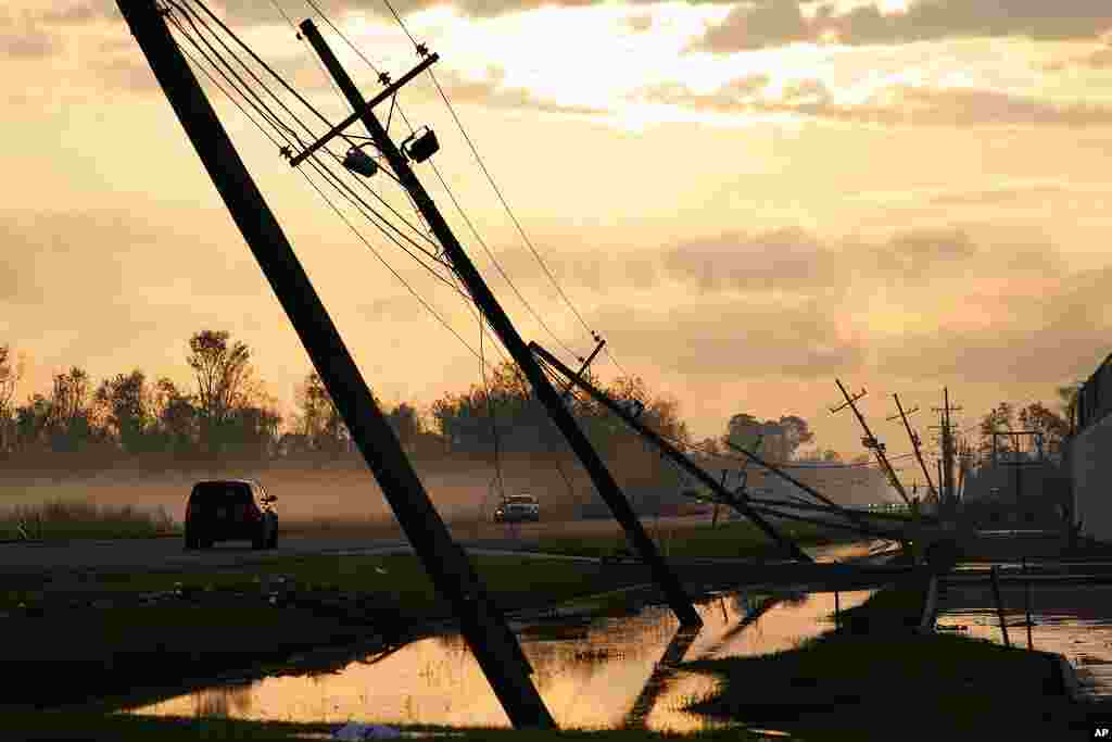 Downed power lines are seen falling over a road after Hurricane Ida, in Reserve, Louisiana.