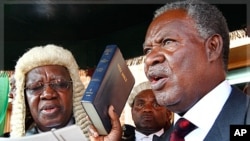 Zambia's new President Michael Sata, right, takes the oath of office on the steps of the supreme court in Lusaka, Zambia, Friday Sept. 23, 2011.