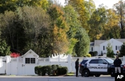 Police officers stand in front of property owned by former Secretary of State Hillary Clinton and former President Bill Clinton in Chappaqua, N.Y., Oct. 24, 2018.