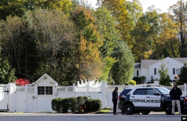 Police officers stand in front of property owned by former Secretary of State Hillary Clinton and former President Bill Clinton in Chappaqua, N.Y., Oct. 24, 2018.