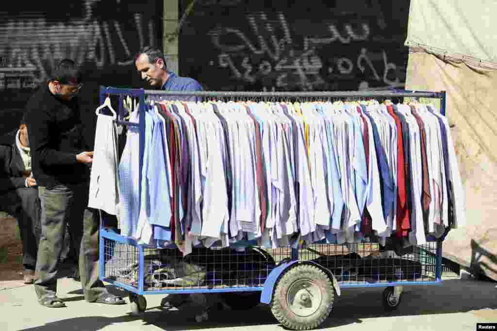 A man sells clothes in Aleppo March 24, 2013.