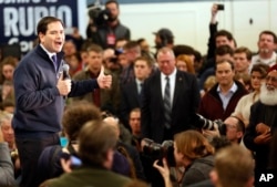 Republican presidential candidate Sen. Marco Rubio, R-Fla., works to charge up a crowd during a campaign stop in a high school cafeteria, Sunday, Feb. 7, 2016, in Londonderry, N.H.