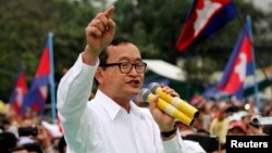 FILE - Sam Rainsy, shown at a Phnom Penh rally in 2013, says his Cambodian National Rescue Party would support Hang Puthea as the ninth, neutral member of the National Election Committee.
