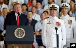 President Donald Trump, left, puts the USS Gerald Ford into commission as Navy commanders listen, at Naval Station Norfolk in Norfolk, Virginia, July 22, 2017.