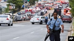 A Metropolitan Police Department officer walks near the Washington Navy Yard, Sept. 16, 2013.