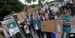 Protesters chant slogans against President Donald Trump's executive order on Muslim immigration in downtown Miami, Jan. 26, 2017.