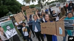 Description: Protesters chant slogans against President Donald Trump's executive order on Muslim immigration, Thursday, Jan. 26, 2017, in downtown Miami. The protesters manifested their opposition to Trump's executive order restricting immigration from some Muslim-majority nations.