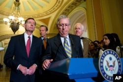 Senate Majority Leader Mitch McConnell of Ky., center, accompanied by, from left, Sen. John Barrasso, R-Wyo., Sen. John Thune, R-S.D., and Senate Majority Whip John Cornyn of Texas, pauses during a news conference on Capitol Hill, April 5, 2016.