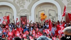 Demonstrators gather during a protest against Tunisian President Kais Saied in Tunis, Tunisia, Sept. 26, 2021.